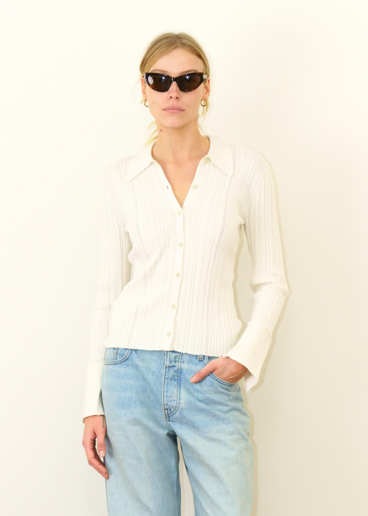 Person wearing Sablyn Joan Cashmere Button Front Sweater in Gardenia