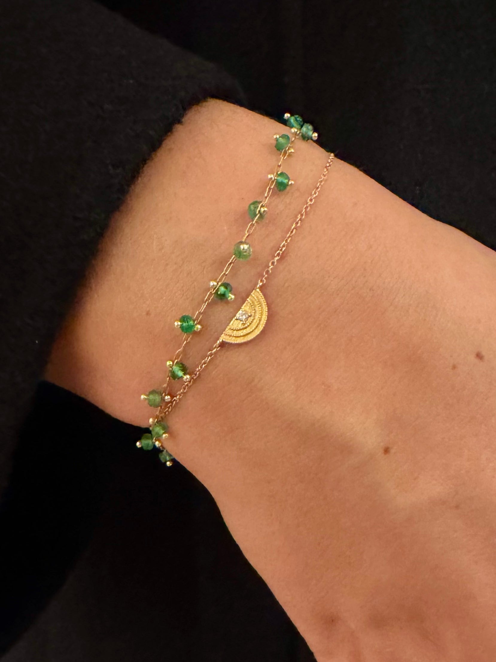 Person wearing Andrea Fohrman fine jewelry 14k yellow gold Gold Diamond Rainbow Charm Bracelet