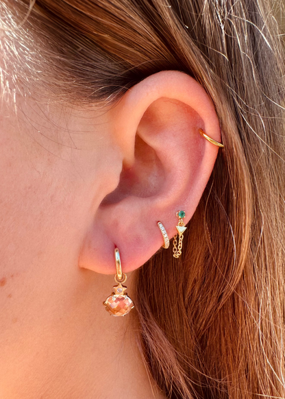Person wearing Andrea Fohrman fine jewelry 14k yellow gold Mini Cosmo Hoop Earrings with Morganite