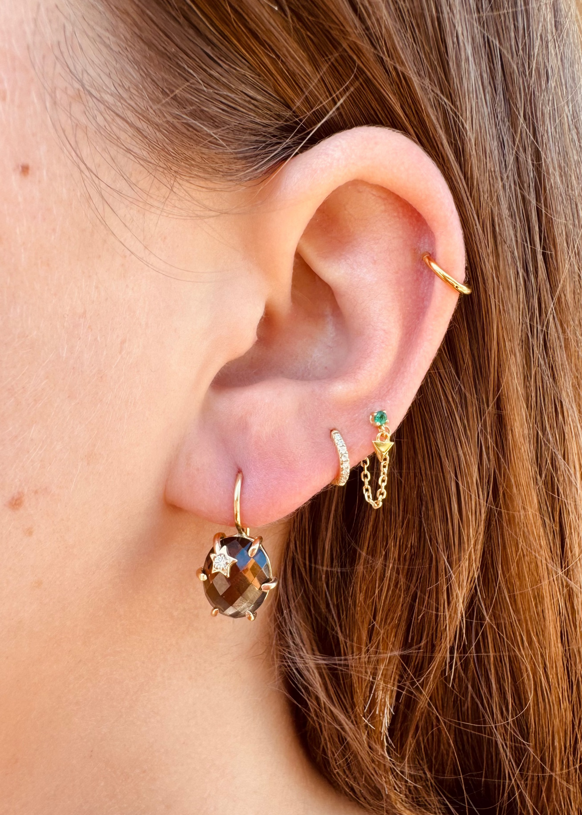 Person wearing Andrea Fohrman fine jewelry 14k yellow gold Mini Galaxy Earrings with Smokey Quartz
