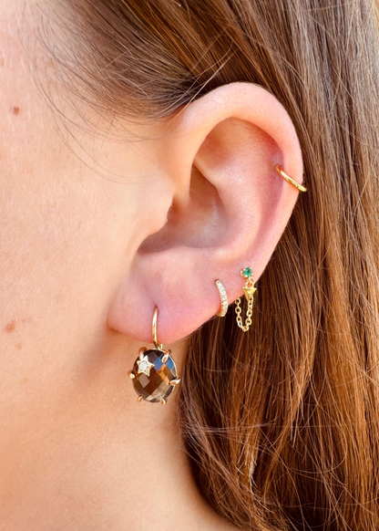 Person wearing Andrea Fohrman fine jewelry 14k yellow gold Mini Galaxy Earrings with Smokey Quartz