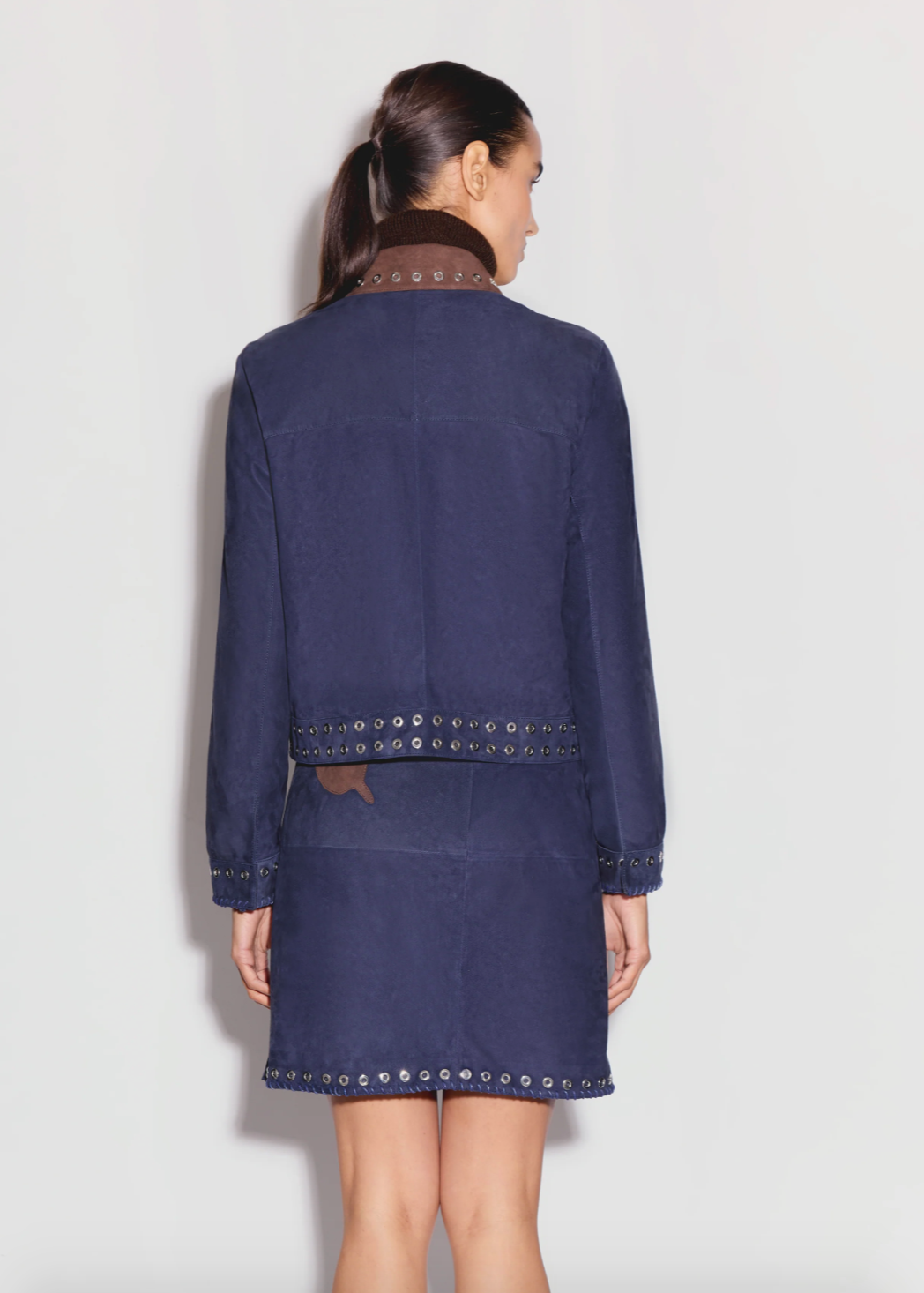 Person wearing Anim womens MAVEN navy Collared Suede Jacket With Pockets, Embroidery AND Grommet Details