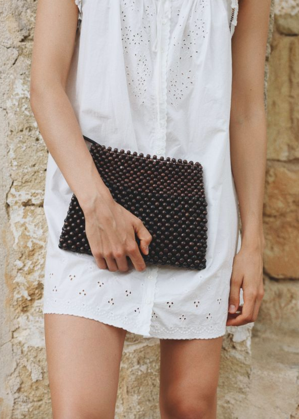 person carrying BEMBIEN-Lotte beaded clutch in Brown