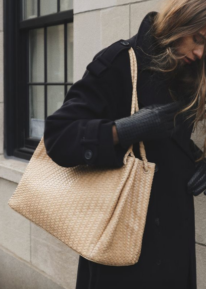 Person carrying Bembien Lux Tote in Caramel woven leather