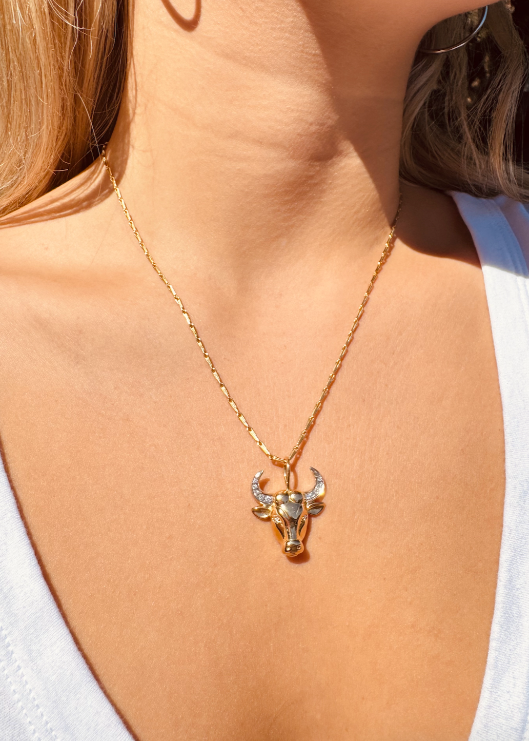 Person wearing Brent Neale fine jewelry 18k yellow gold and diamond Medium Zodiac Taurus Pendant Necklace