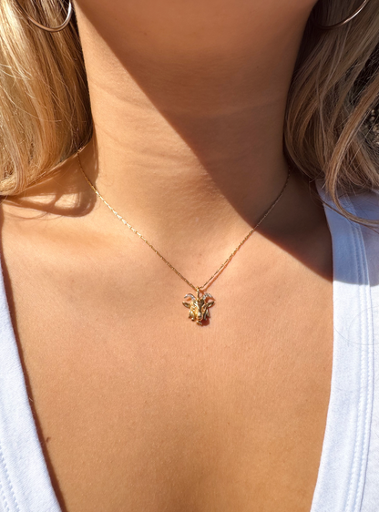 Person wearing Brent Neale fine jewelry 18k yellow gold diamond Small Zodiac Capricorn Pendant Necklace