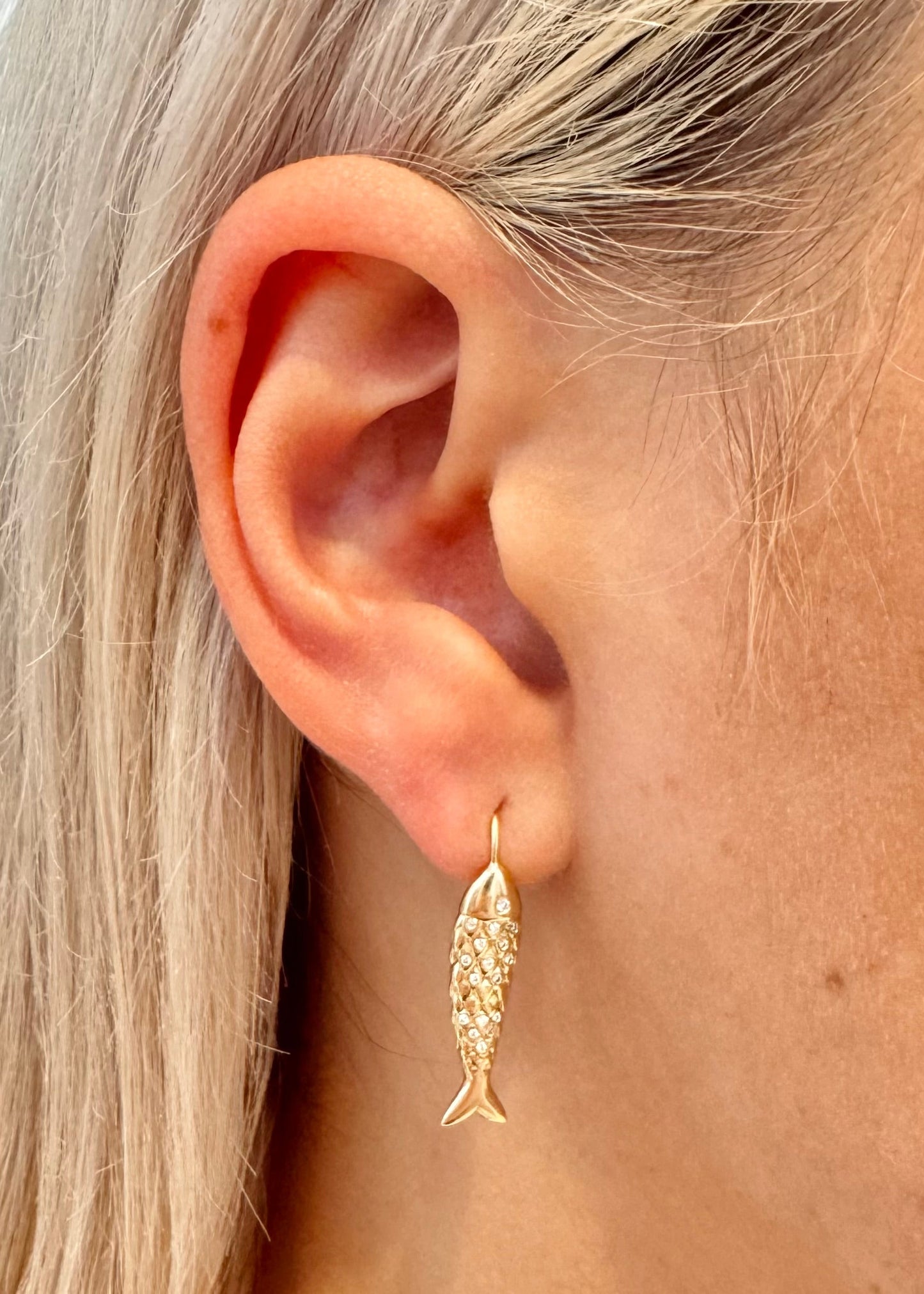 Person wearing Brent Neale fine jewelry 18k yellow gold diamonds small fish hook earrings