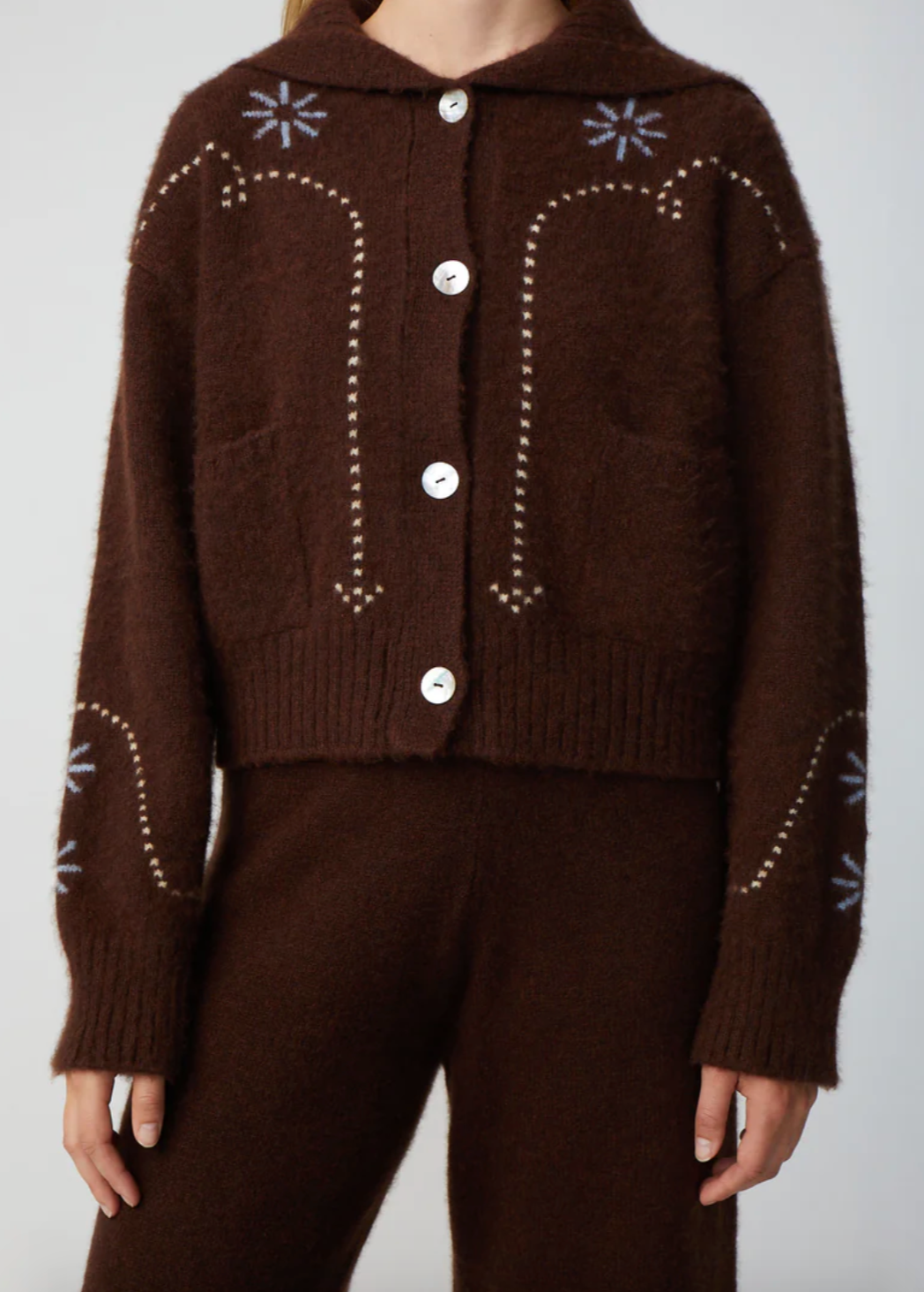 Person wearing Calle del Mar Western Cashmere Cardigan in Chocolate