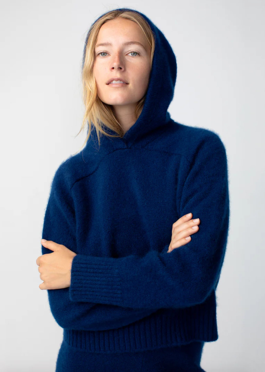 Person wearing Calle del Mar womens Cashmere Hoodie in Navy Blue