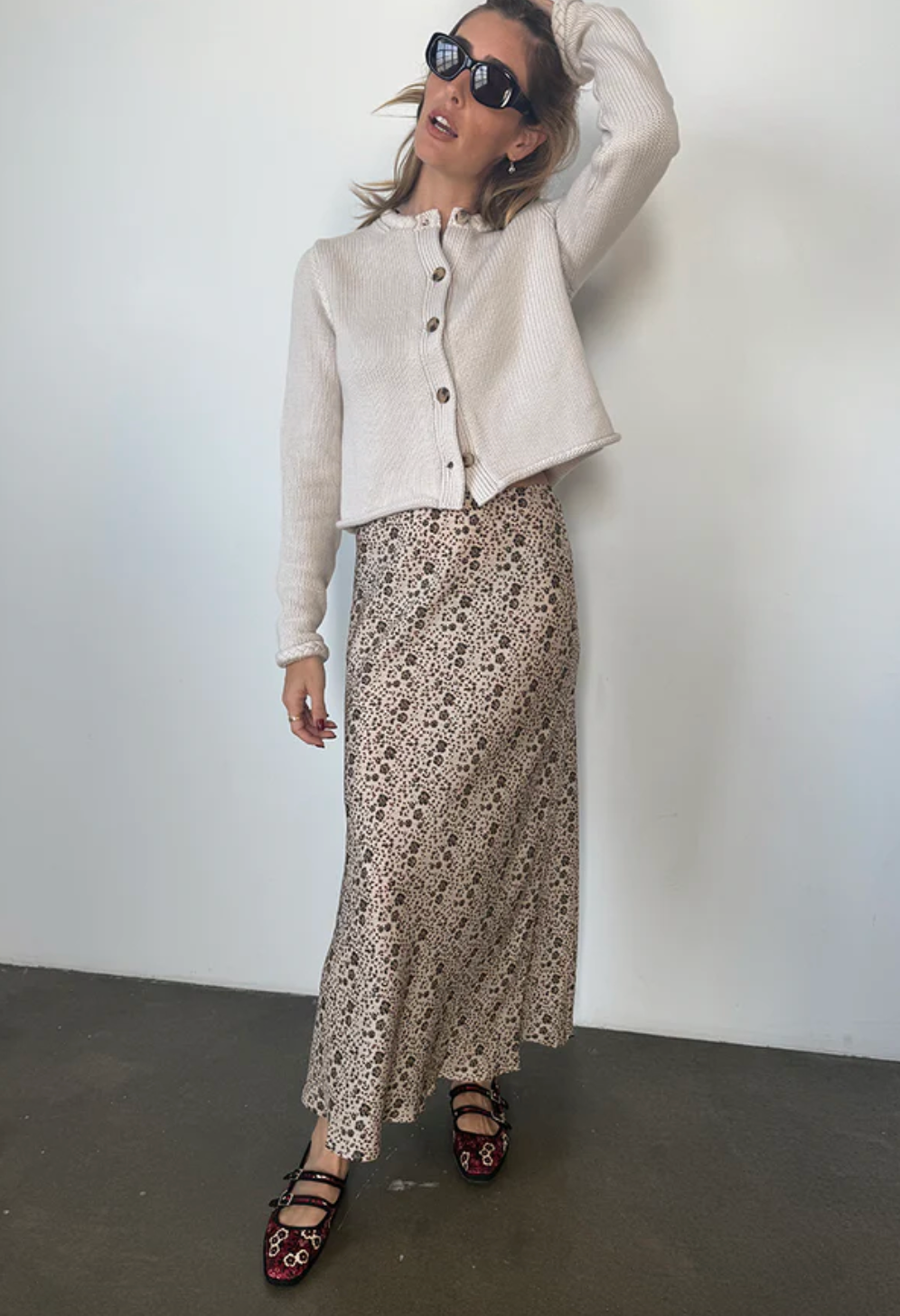 Person wearing Ciao Lucia Concetta Printed Silk Cherry Blossom Skirt