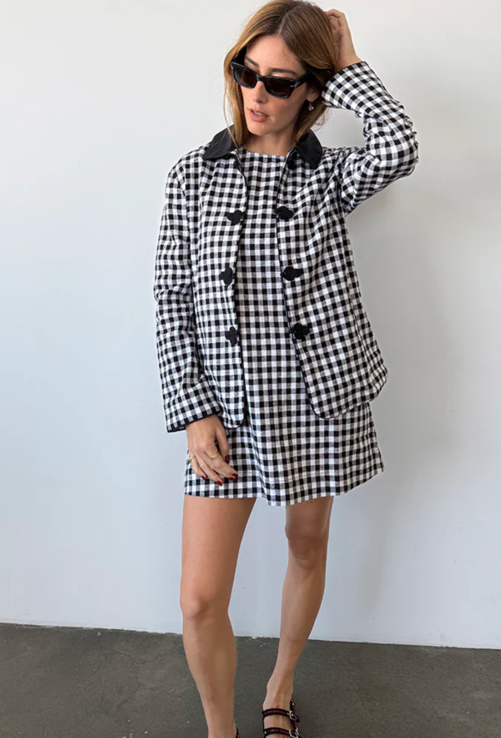 Person wearing Ciao Lucia Indus Gingham Dress Black and White