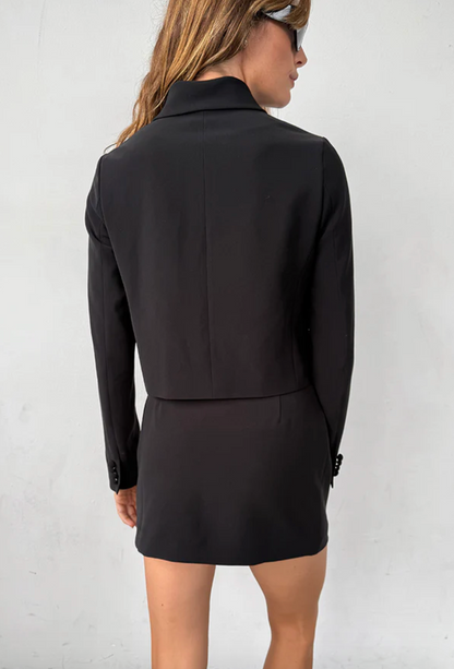 Person wearing Ciao Lucia Lotta Skirt in Black Suiting