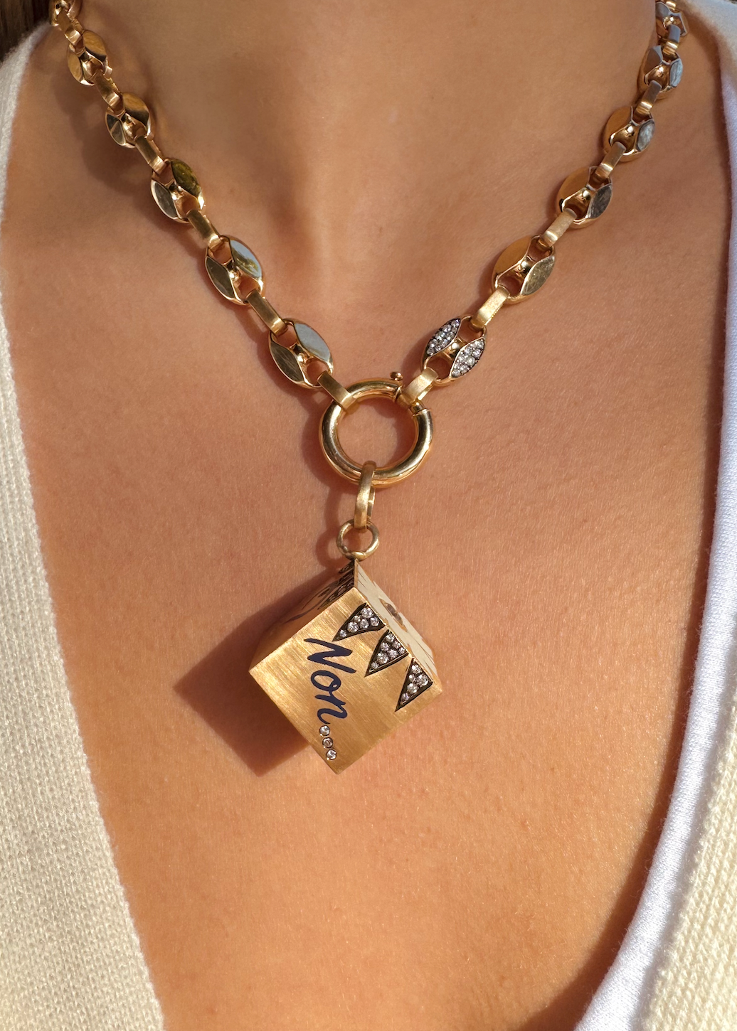 Person wearing Circa 1700 fine jewelry 18k yellow gold Chunky Mariner Knife Edge Link Chain with diamonds with spinnin the dice XL pendant