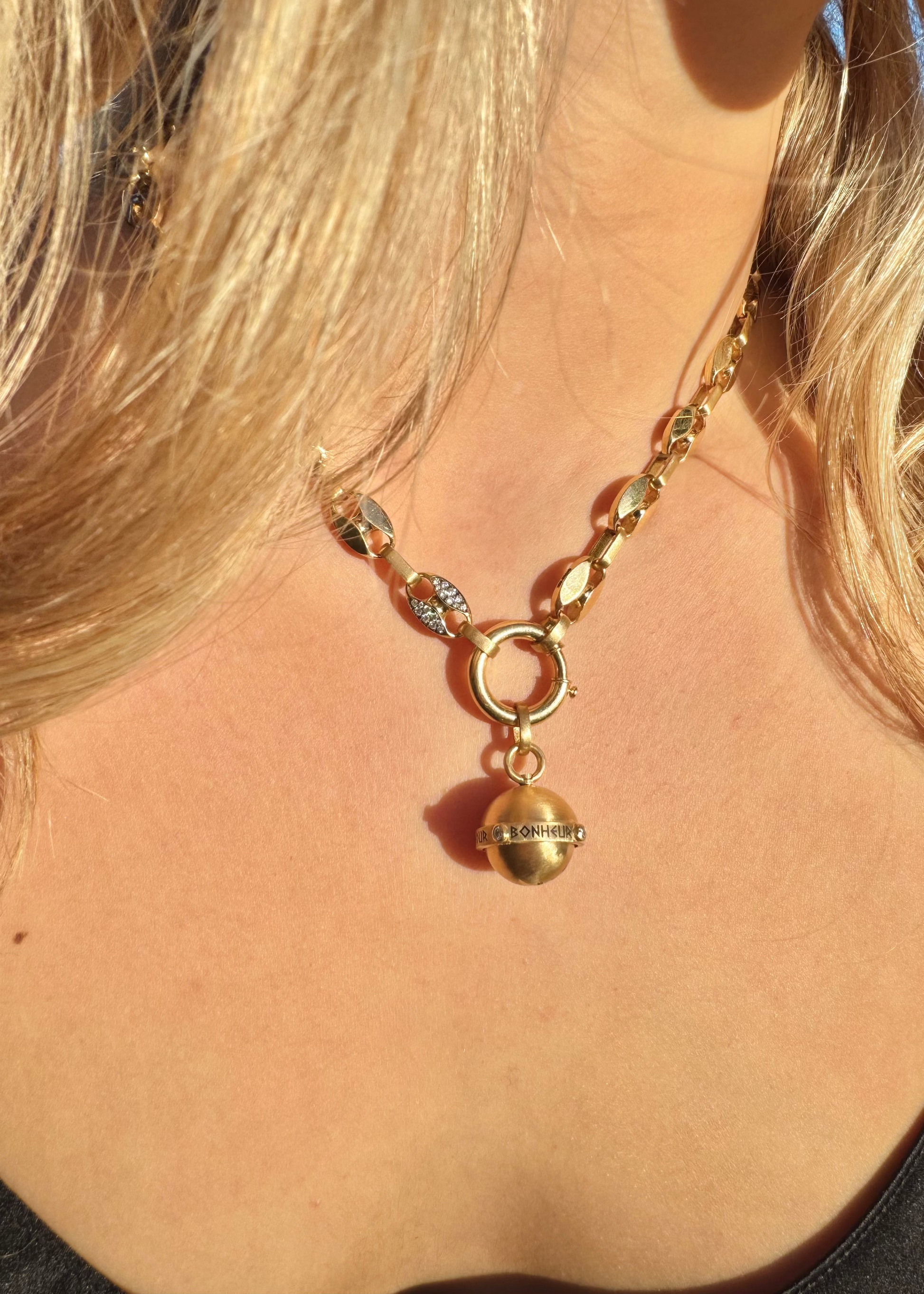 Person wearing Circa 1700 fine jewelry 18k yellow gold diamond Love, Strength, Health & Happiness Secret Talisman Spinning Orb Pendant