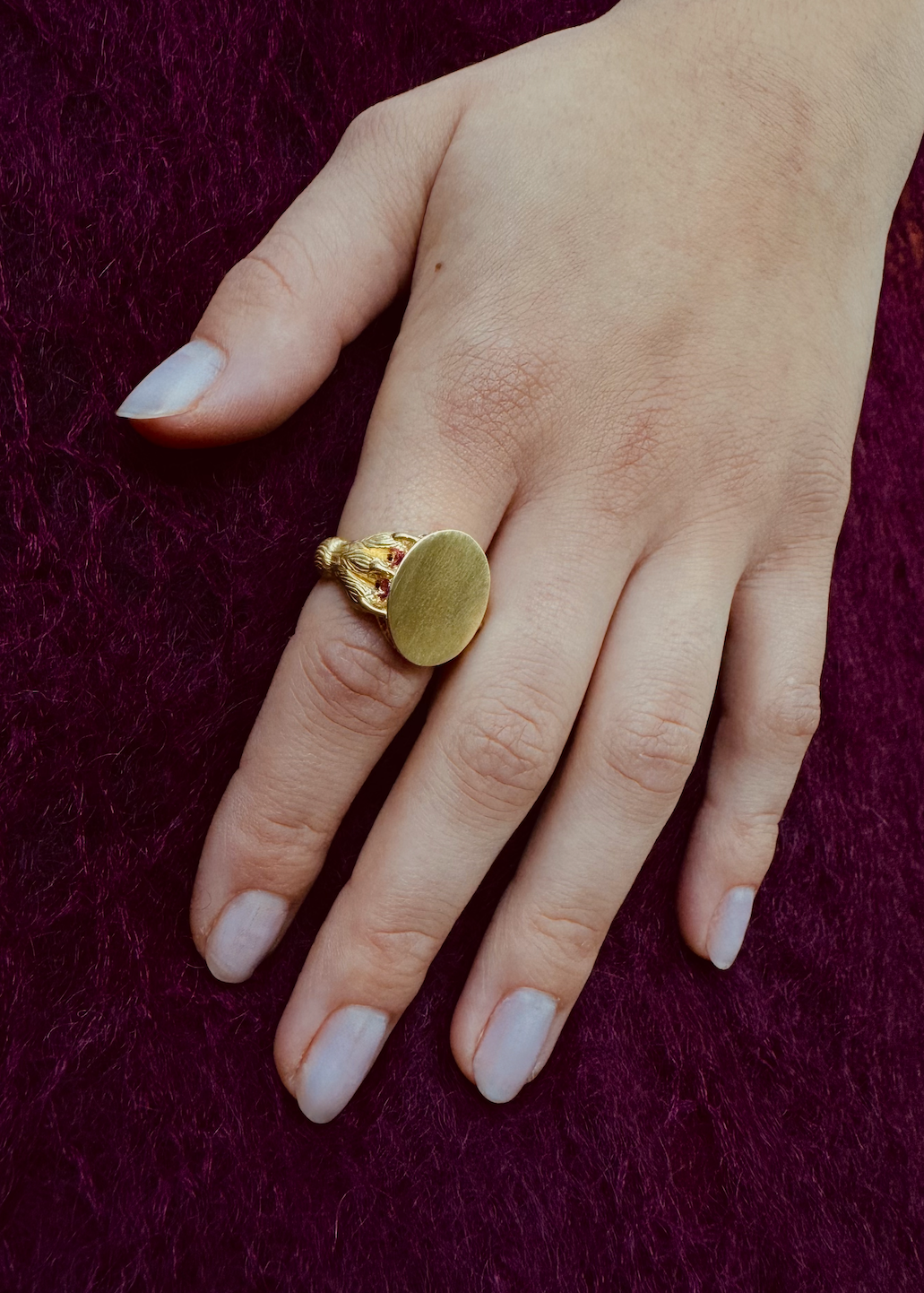 Person wearing Circa 1700 fine jewelry 18k yellow gold pink ruby Claw in the Love Signet