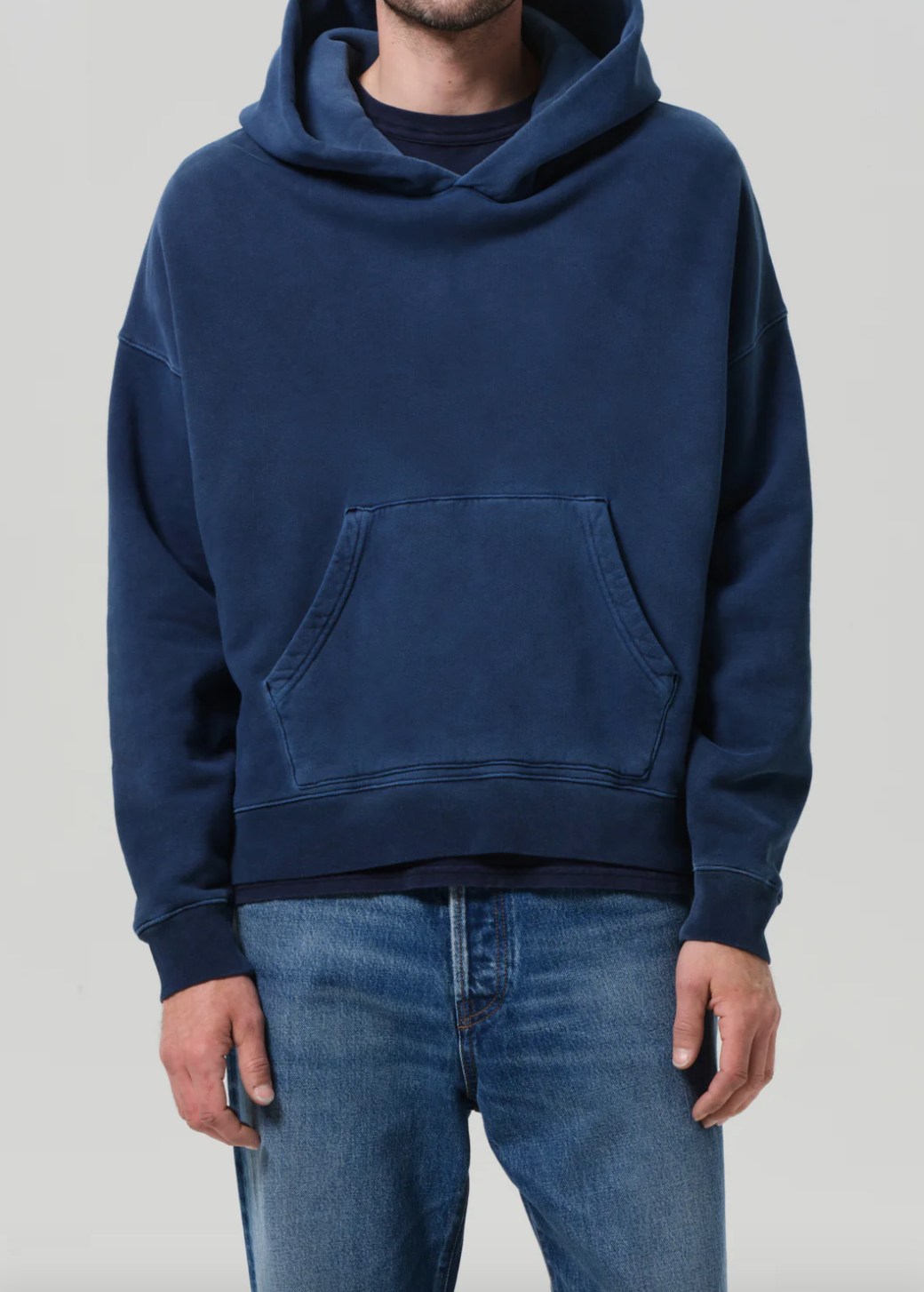 Person wearing Citizens of Humanity Mens Archive Hoodie in Indigo Blue