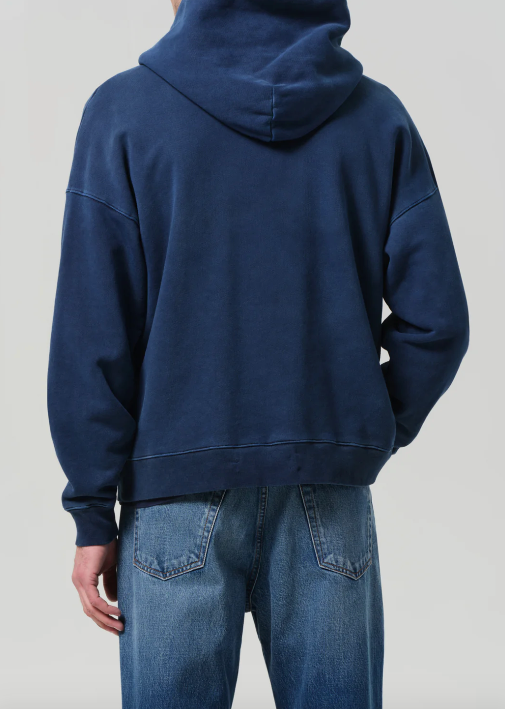 Person wearing Citizens of Humanity Mens Archive Hoodie in Indigo Blue