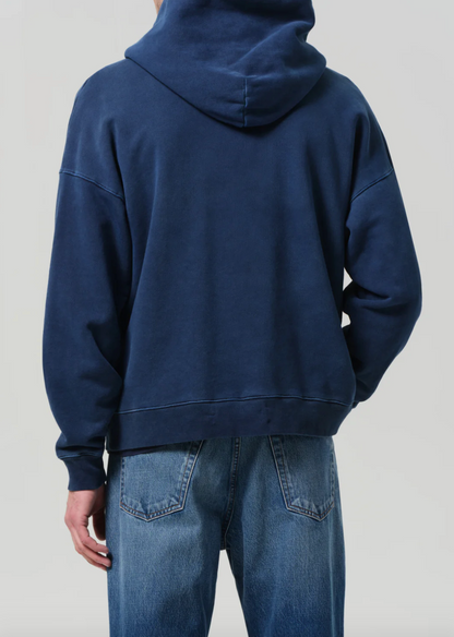 Person wearing Citizens of Humanity Mens Archive Hoodie in Indigo Blue