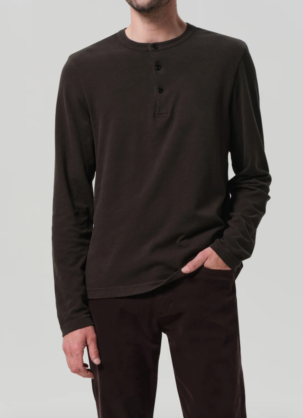 Person wearing Citizens of Humanity Mens Three Button Henley in Forest Green