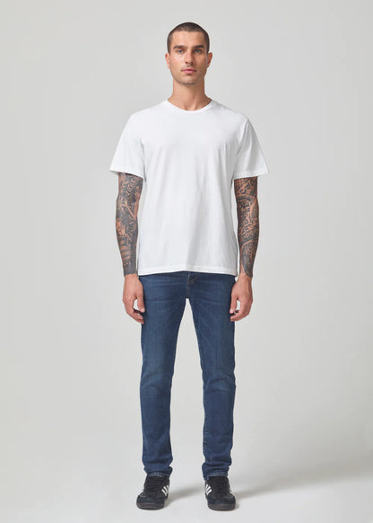 Person wearing Citizens of Humanity mens Matteo Relaxed Taper Jeans in All Roads