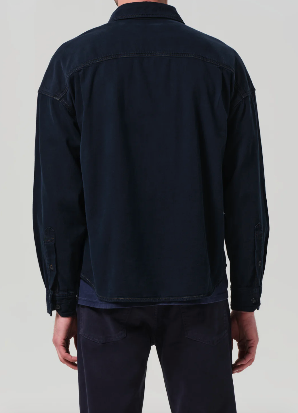 Person wearing Citizens of Humanity mens Shigoto Shirt Jacket in Dark Indigo