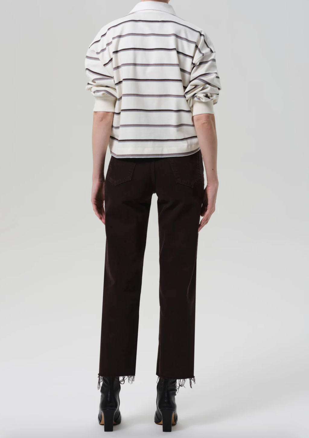 Person wearing Citizens of Humanity womens Palma Straight Leg Denim Jeans Raw Hem in Carob Brown