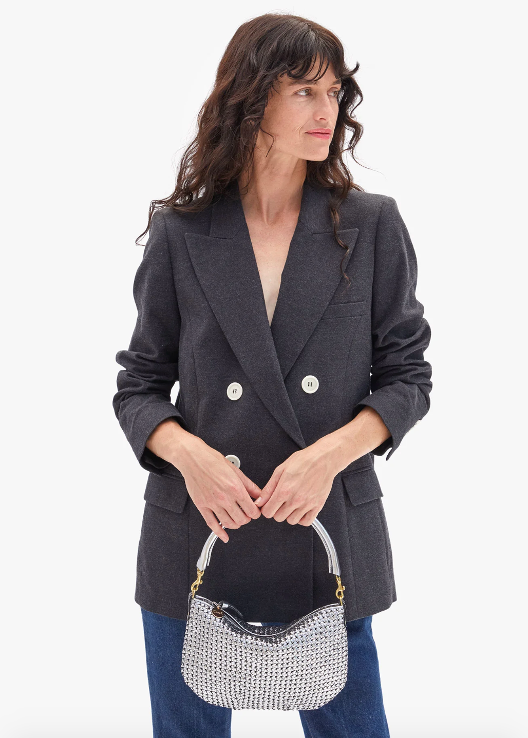 Person carrying Clare V Petit Moyen Messenger Handbag in Silver Leather Woven Etoile