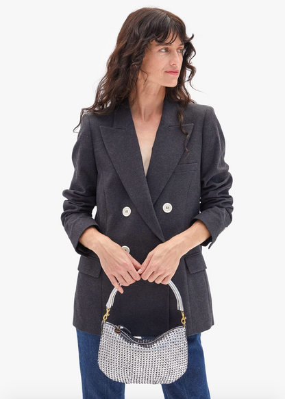 Person carrying Clare V Petit Moyen Messenger Handbag in Silver Leather Woven Etoile