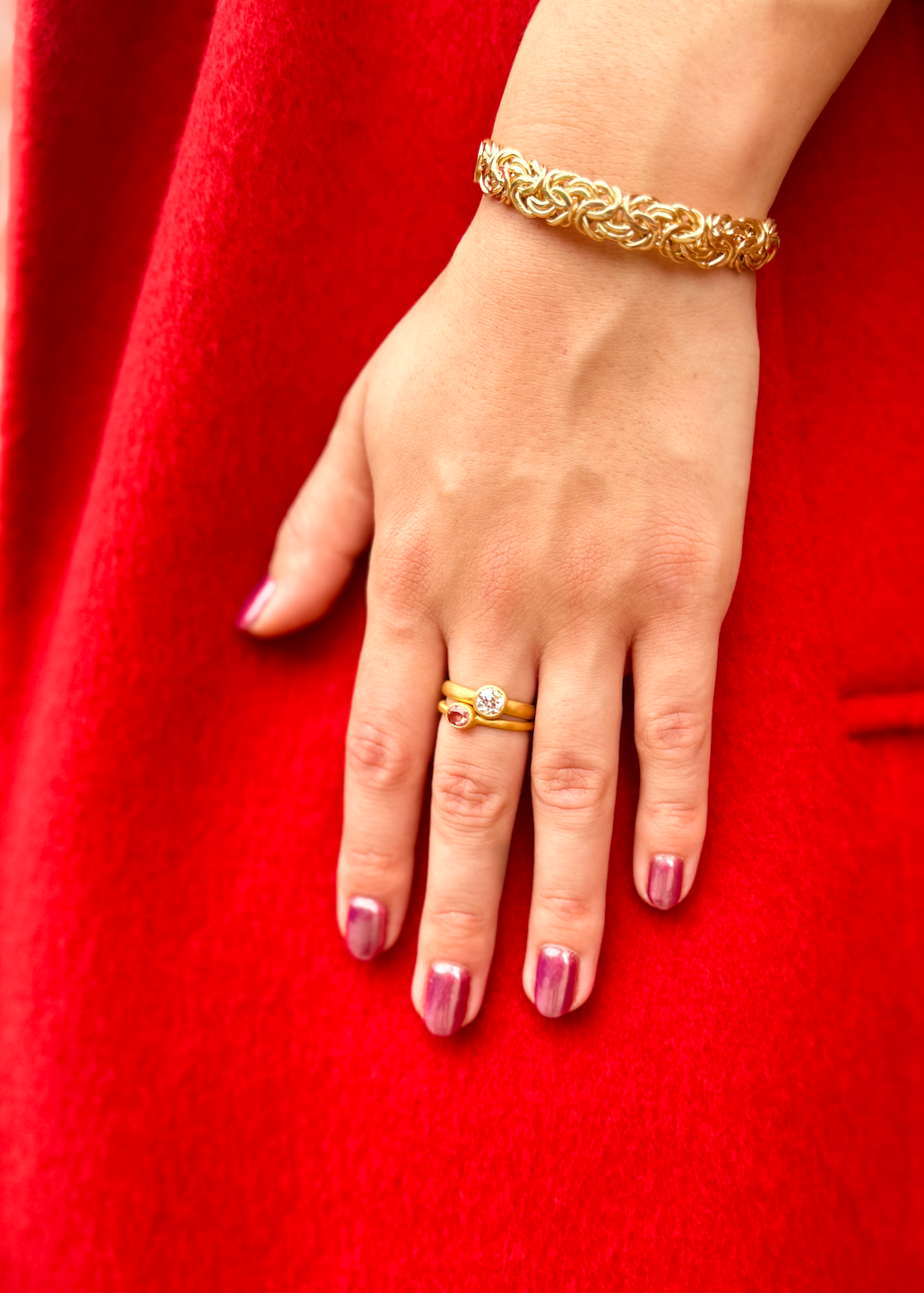 Person wearing Darius fine jewelry 18k yellow gold Padparascha Sapphire Gem Fairy Band and Old Euro Diamond Gem Signature Band