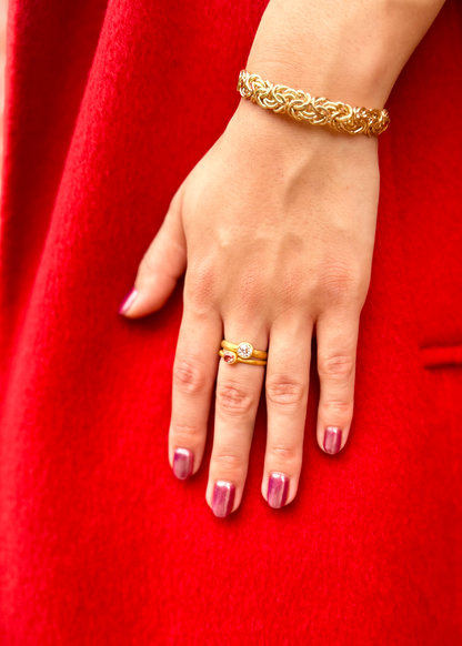 Person wearing Darius fine jewelry 18k yellow gold Padparascha Sapphire Gem Fairy Band and Old Euro Diamond Gem Signature Band