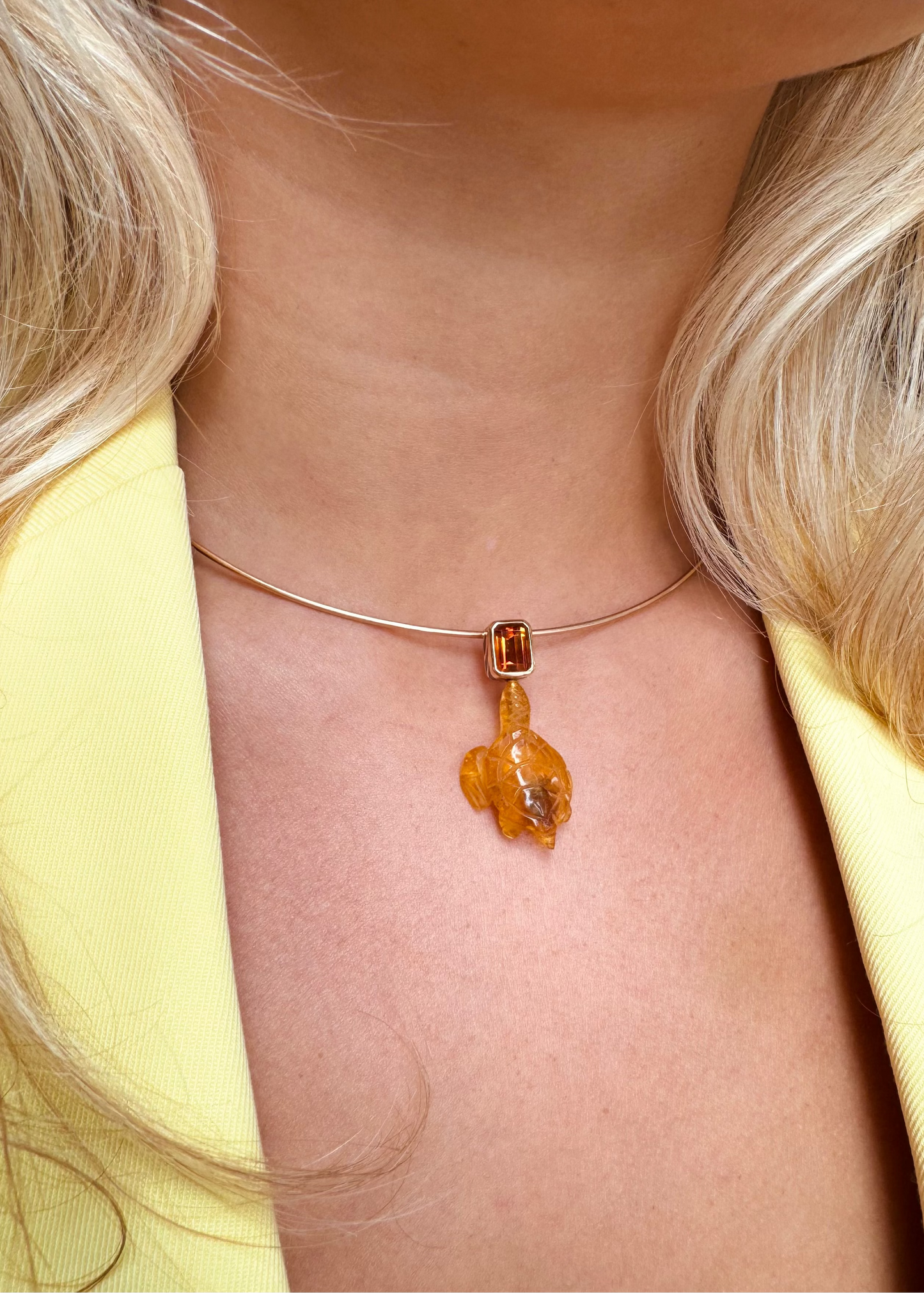 person wearing Dezso fine jewelry 18k rose gold Carved Amber Turtle Charm with Citrine