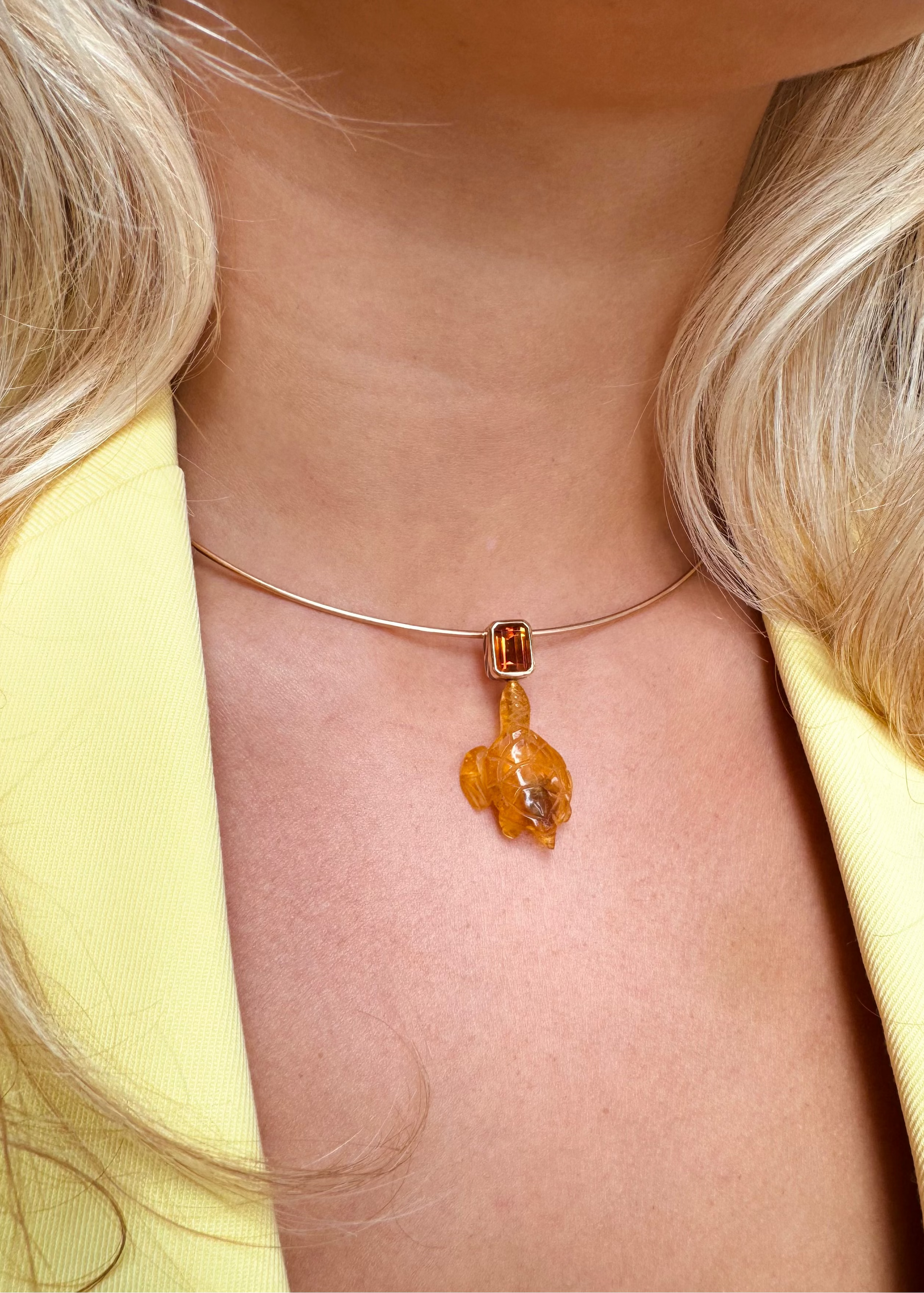 person wearing Dezso fine jewelry 18k rose gold Carved Amber Turtle Charm with Citrine