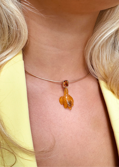 person wearing Dezso fine jewelry 18k rose gold Carved Amber Turtle Charm with Citrine