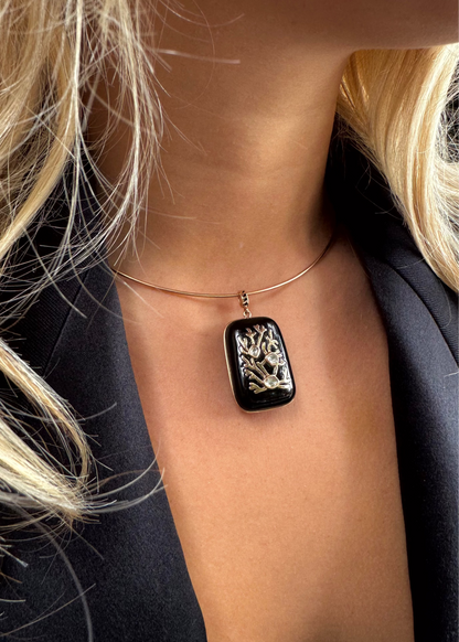 person wearing Dezso fine jewelry 18k rose gold Coral Inlay Charm in Onyx and Polki Diamonds