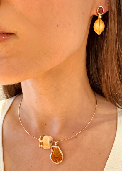 person wearing Dezso fine jewelry 18k rose gold One-of-a-Kind Natural Clam Charm Natural Champagne Shell Bead with Scapolite Natural Cowry Earrings Orange Sapphire
