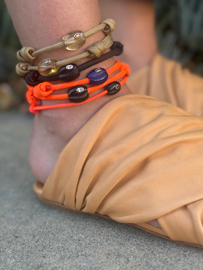 Person wearing Dezso fine jewelry Lemon Quartz & Sapphire Cowry Bead Anklet