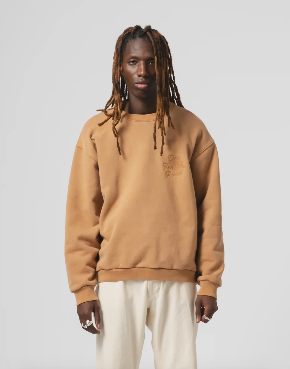 Person wearing Eat Dust Mens Unisex Detroit Sweater in Sugar