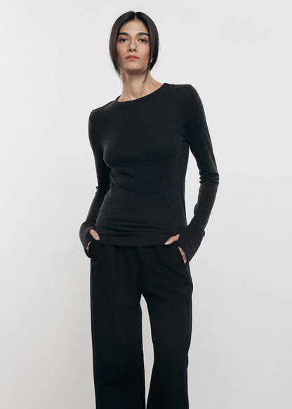 Person wearing Enza Costa womens Cashmere Easy Cuffed Crew in Charcoal