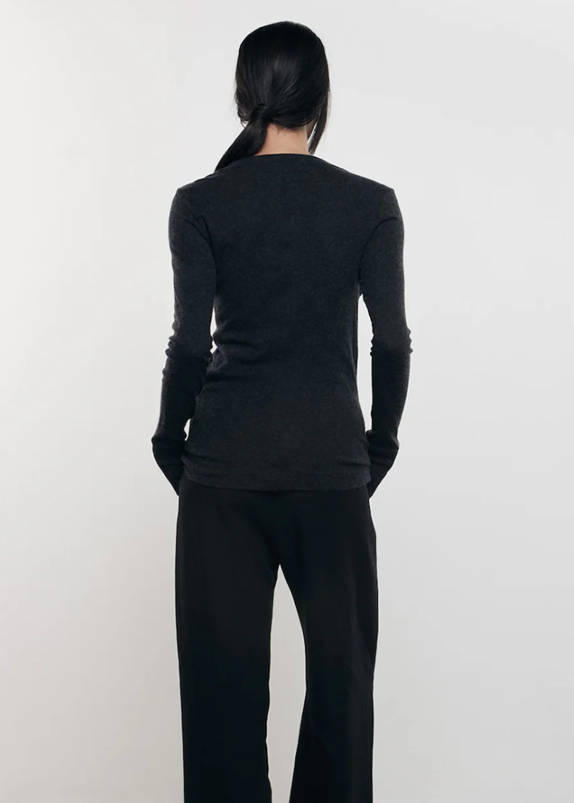 Person wearing Enza Costa womens Cashmere Easy Cuffed Crew in Charcoal