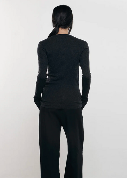 Person wearing Enza Costa womens Cashmere Easy Cuffed Crew in Charcoal
