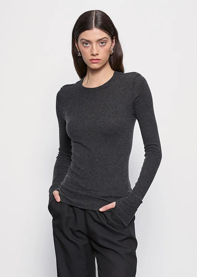 person wearing Enza Costa womens Cashmere Easy Cuffed Crew in Charcoal gray