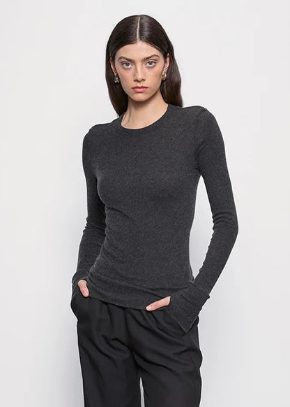 person wearing Enza Costa womens Cashmere Easy Cuffed Crew in Charcoal gray