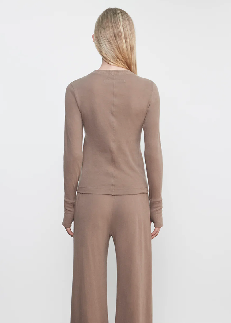 Person wearing Enza Costa womens Cashmere Easy Cuffed Crew in Walnut