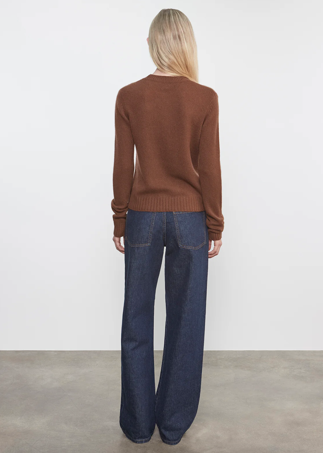 Person wearing Enza Costa womens Cashmere Easy Long Sleeve Crew in Nutmeg
