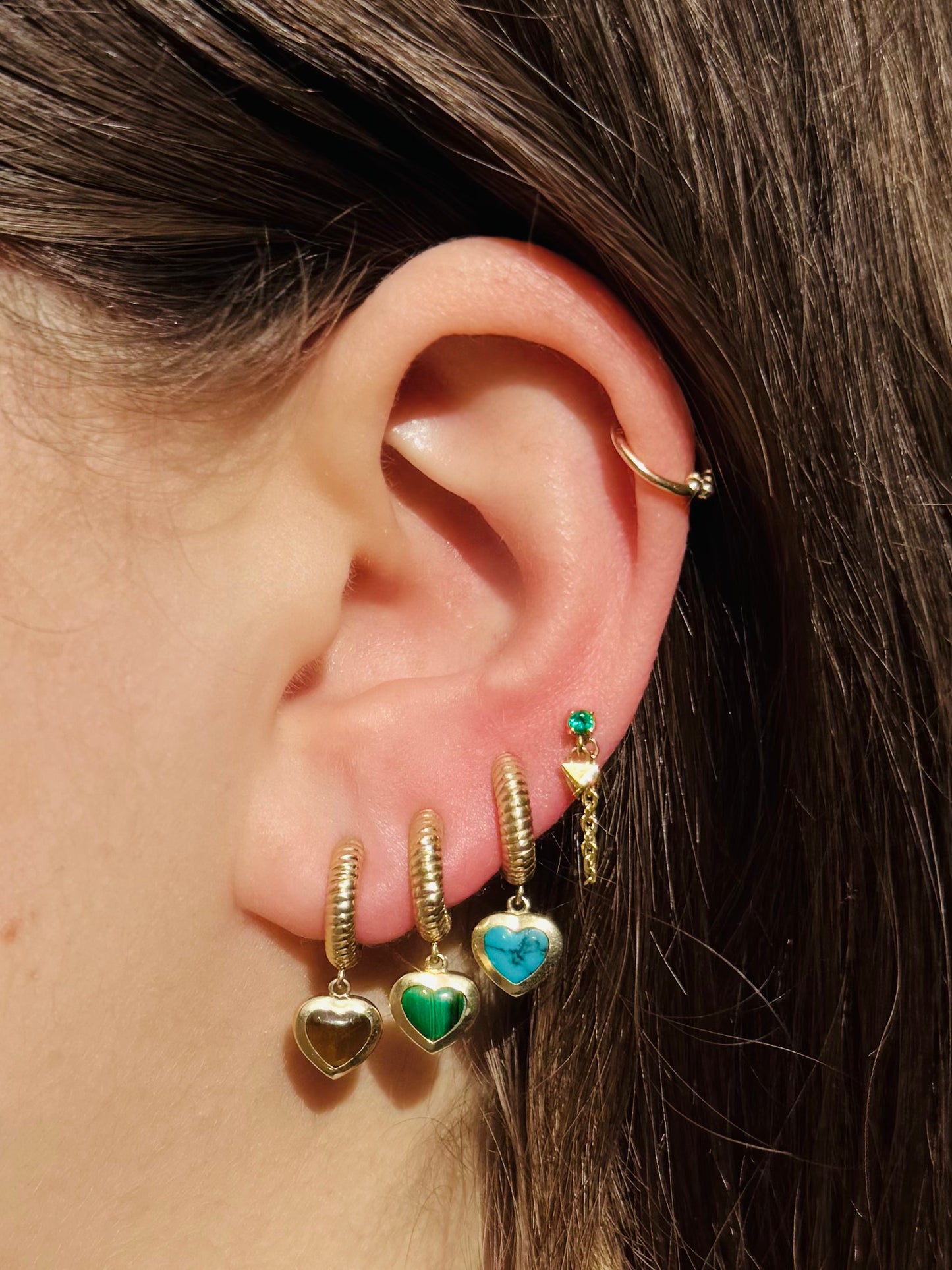 Person wearing Established fine jewelry 14k yellow gold Tigers Eye Malachite Turquoise Heart Rope Huggies