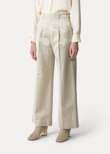 Person wearing Forte Forte High-Rise Herringbone Trousers in Sand