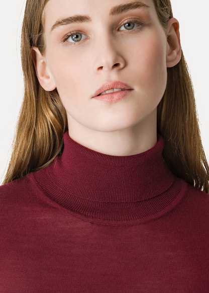 Person wearing Forte Forte High–Neck Sweater in Superfine Merino Wool Bordeaux