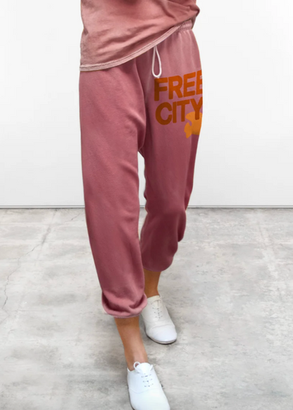 Person wearing FreeCity French Terry Cotton classic sweatpant in mauve with orange 