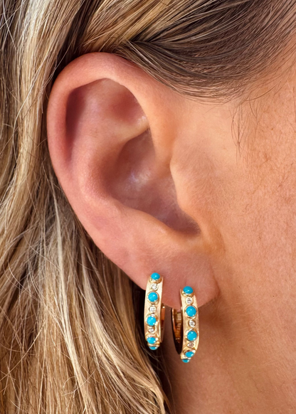 Person wearing Grace Winfrey fine jewelry 18k yellow gold Trio Huggies with Turquoise and Diamonds