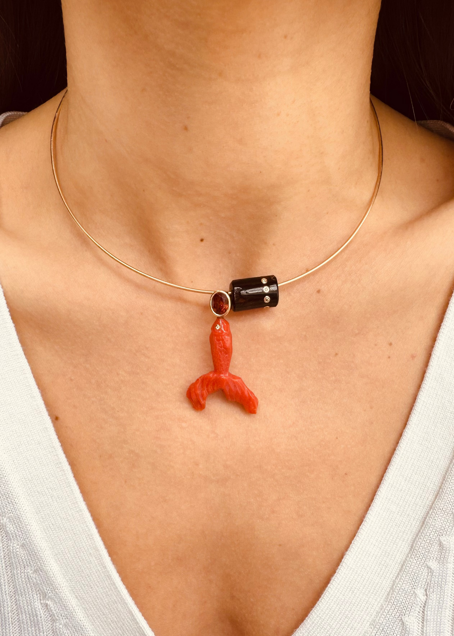 person wearing Hand Carved Coral Fish Charm with Citrine and Coral Bead with Diamonds